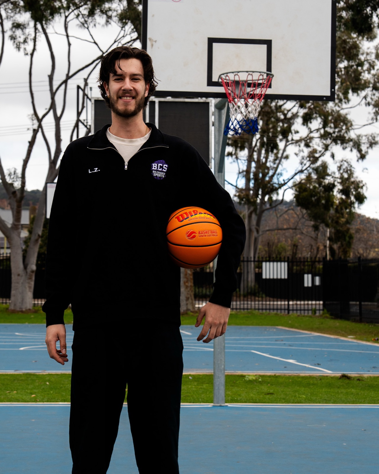Luka Zbierski holding a basketball on an outdoor court